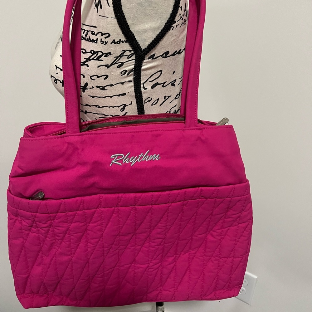Hot pink bag with lots of compartments.